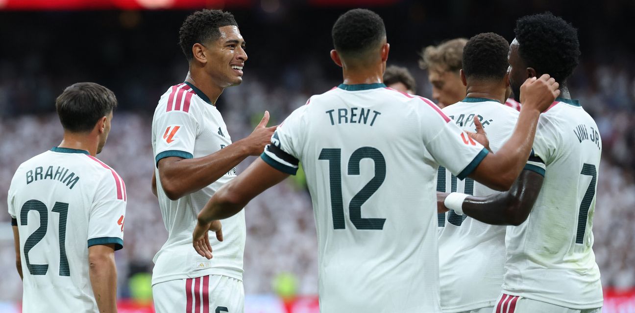 Real Madrid players congratulate one another after scoring against Malaga
