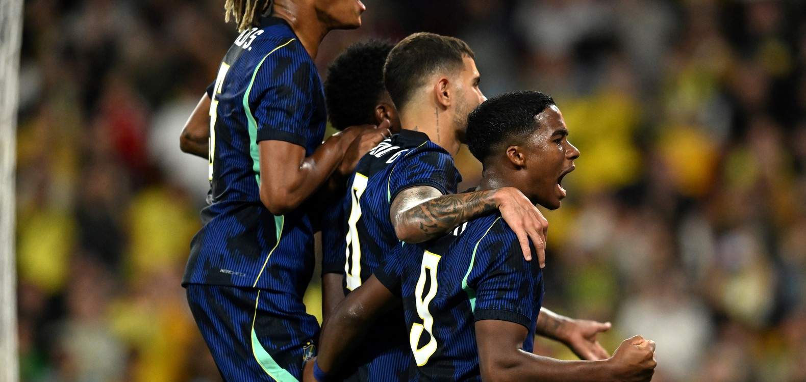 Endrick, Bruno Guimaraes and other Brazil players watch a penalty taken by Raphinha