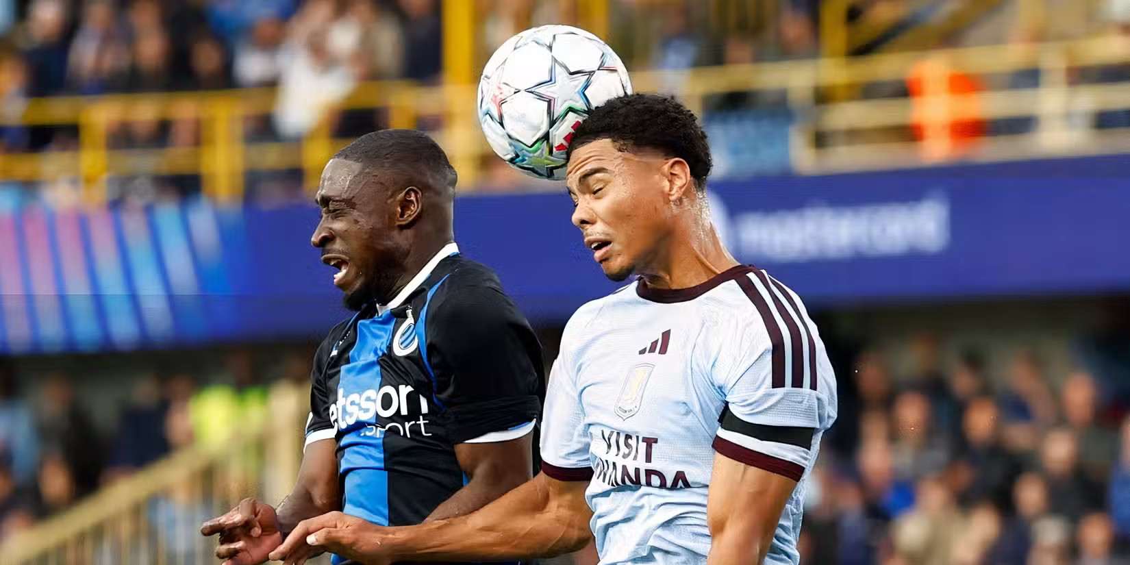 Club Brugge and Aston Villa players in a battle for a high ball