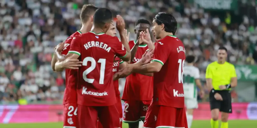 Real Sociedad players congratulate one another after scoring against Elche