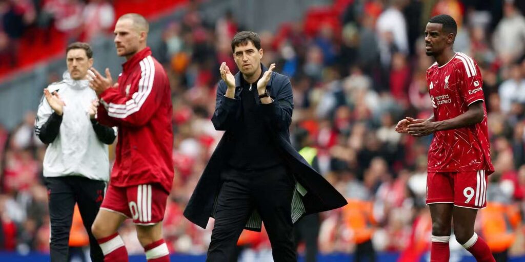 Andoni Iraola, Alexander Isak and Alexis Mac Allister clap at Liverpool's supporters