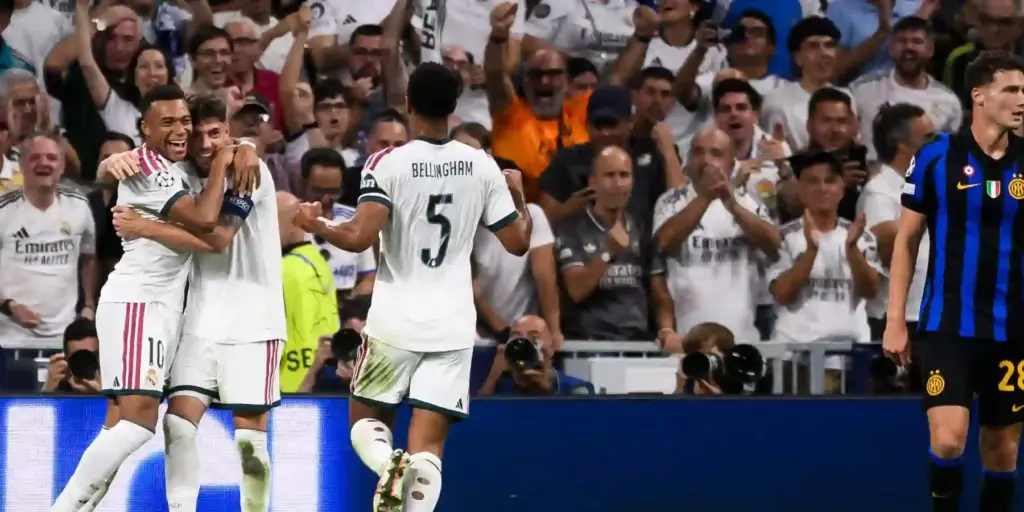 Real Madrid players celebrate after scoring against Inter