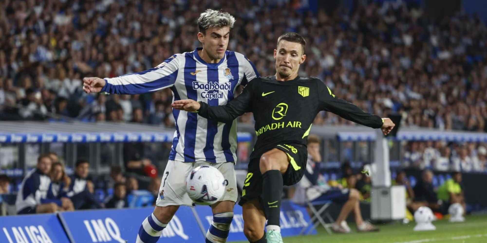 Real Sociedad and Atletico Madrid players in a battle for the ball