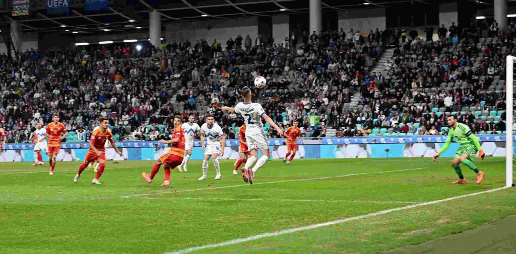 Slovenian player controlling a ball in North Macedonia's box