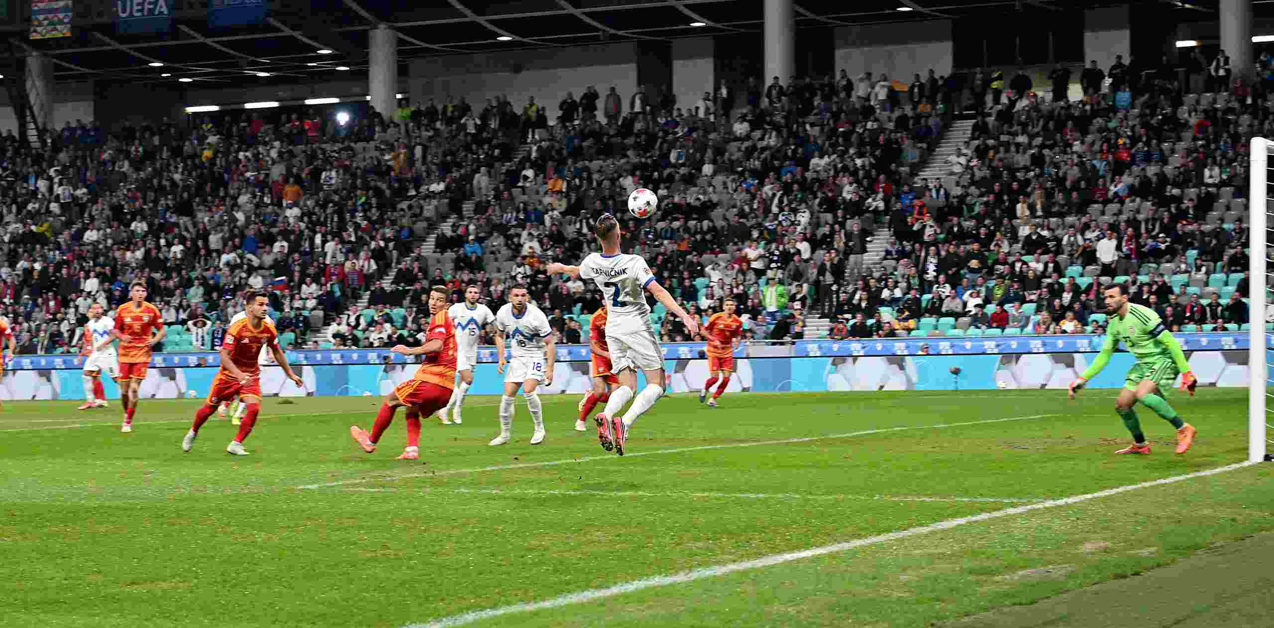 Slovenian player controlling a ball in North Macedonia's box