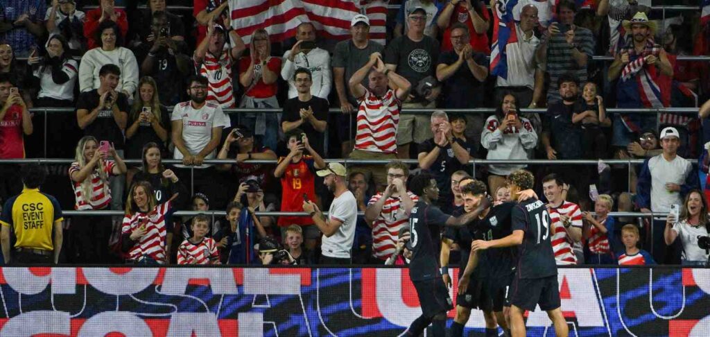 US players celebrate in front of their supporters after scoring against Chile
