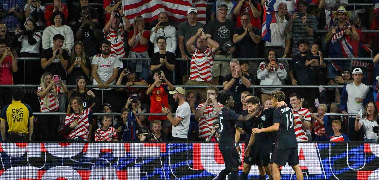 US players celebrate in front of their supporters after scoring against Chile