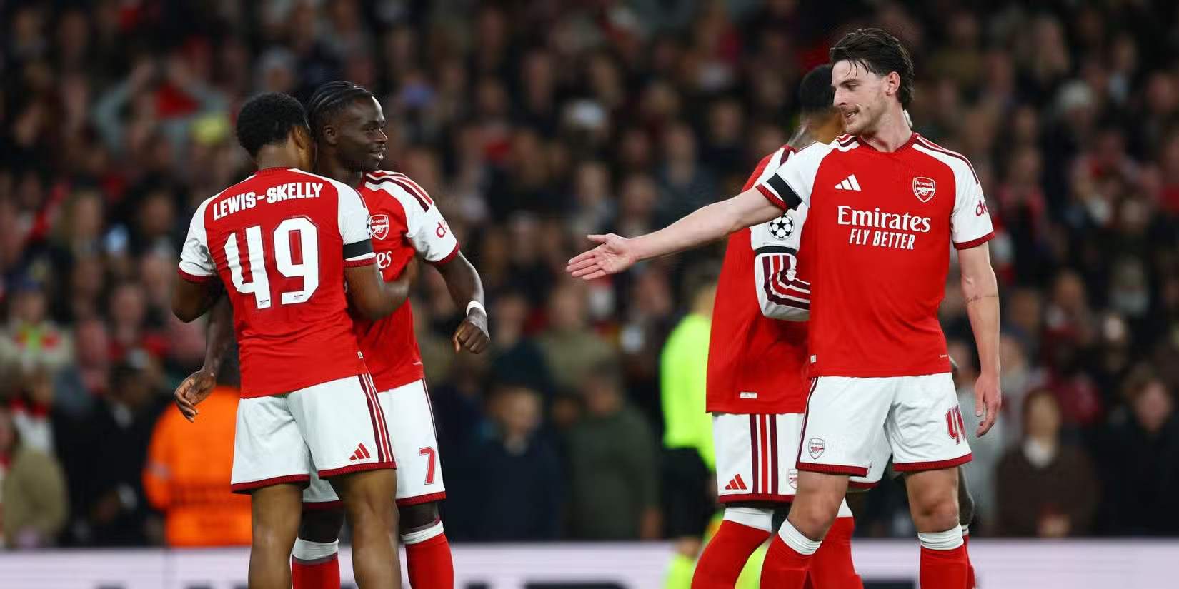 Arsenal players congratulate one another after scoring against Lille