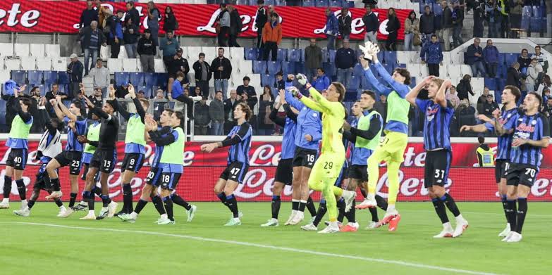 Atalanta players celebrate in front of their supporters after the victory against Venezia