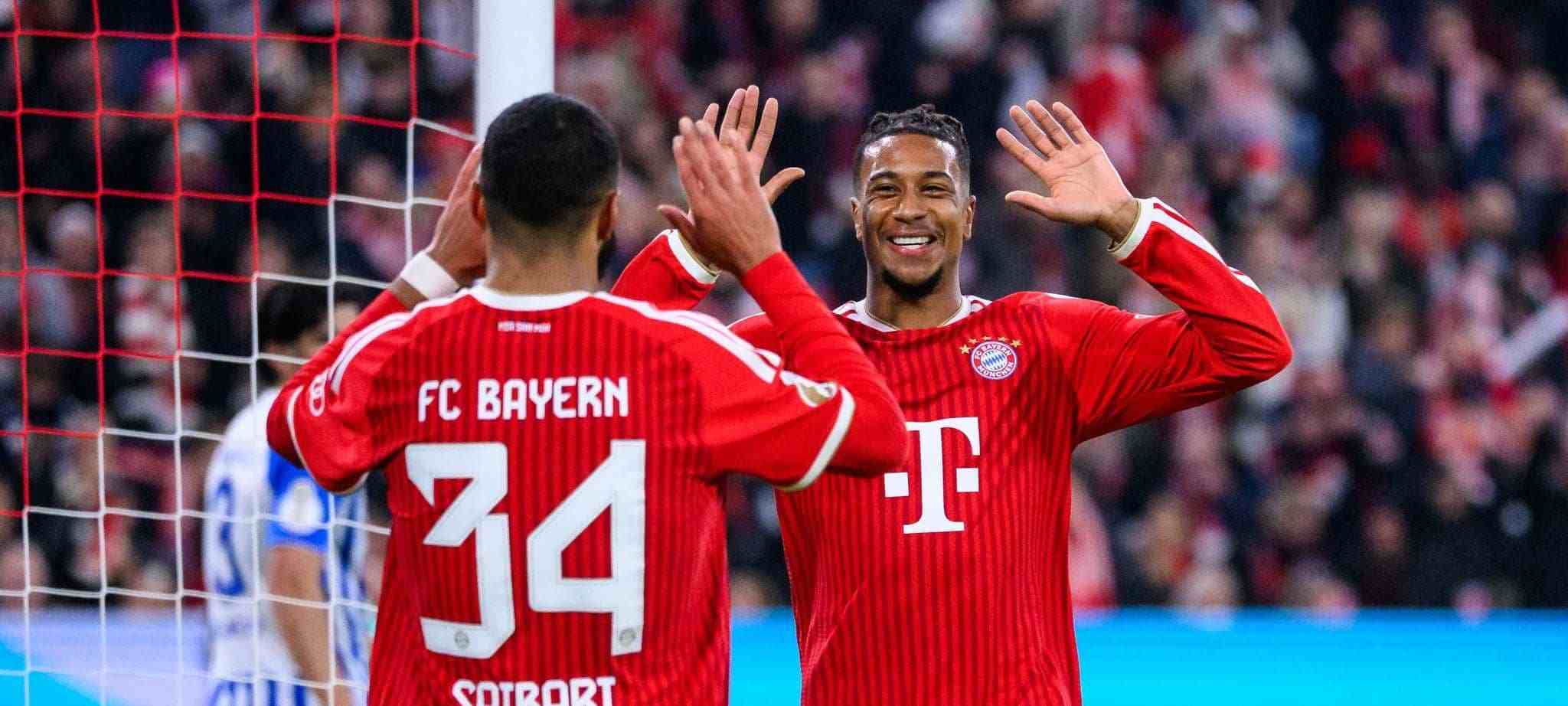 Michael Olise and Ismael Saibari celebrate Bayern's goal against Magdeburg