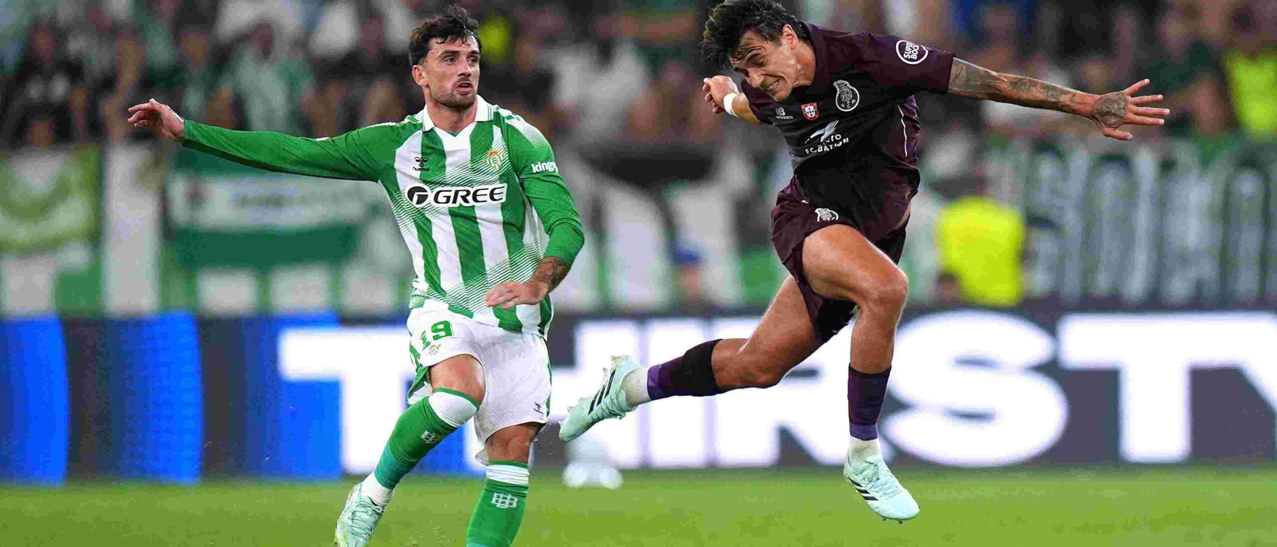 Porto player clears the ball before Troy Parrott