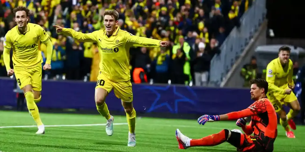 Bodo/Glimt players rush to celebrate after scoring against Borussia Dortmund