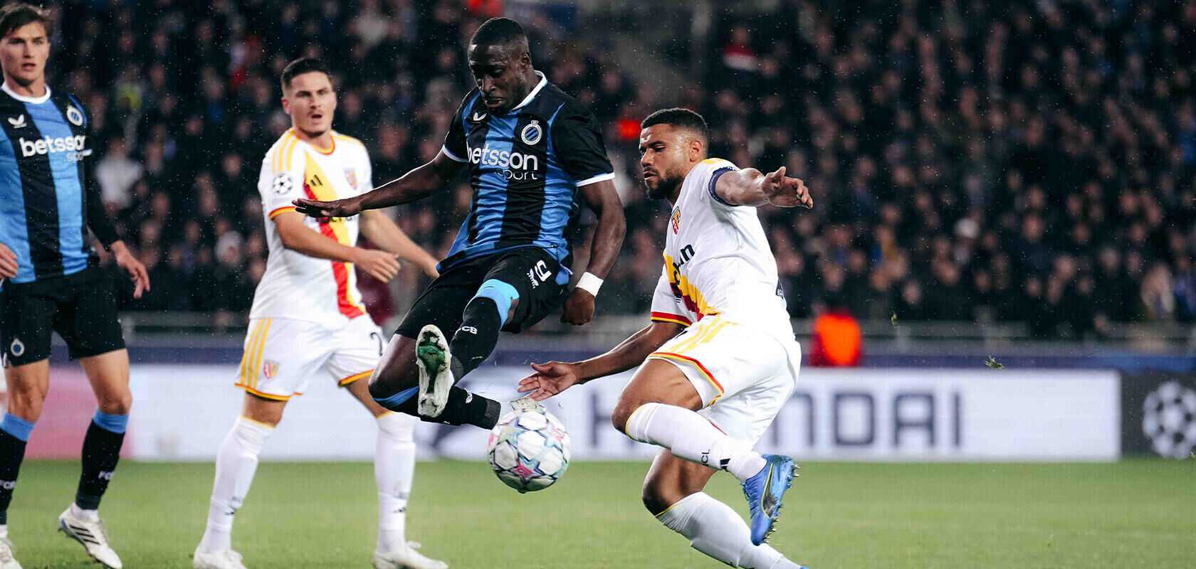 Club Brugge and Lens players in a battle for the ball