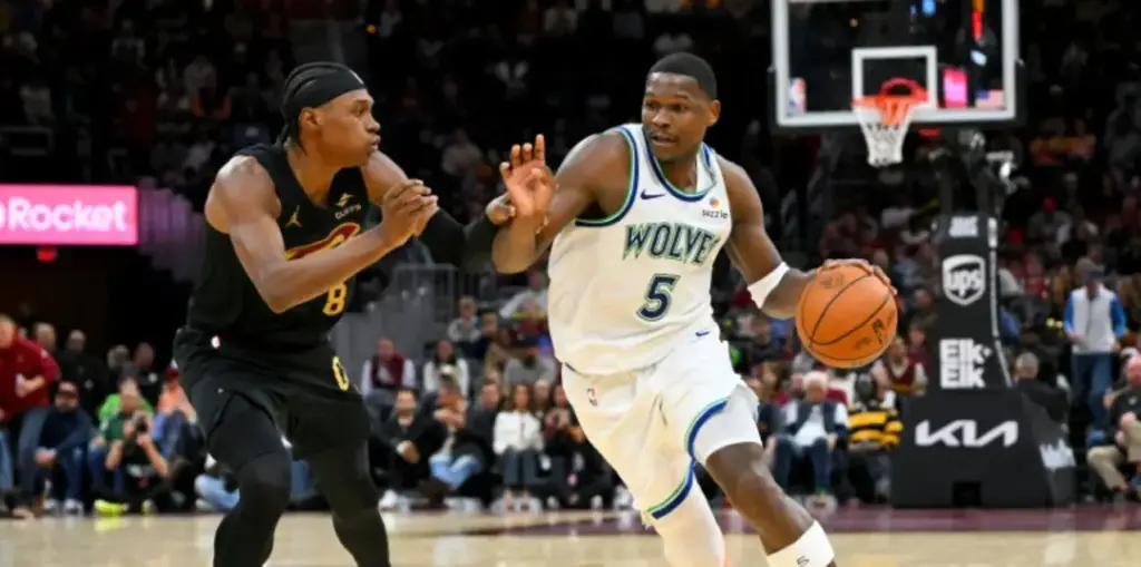 Anthony Edwards dribbling the ball, guarded by a Cleveland Cavaliers opponent