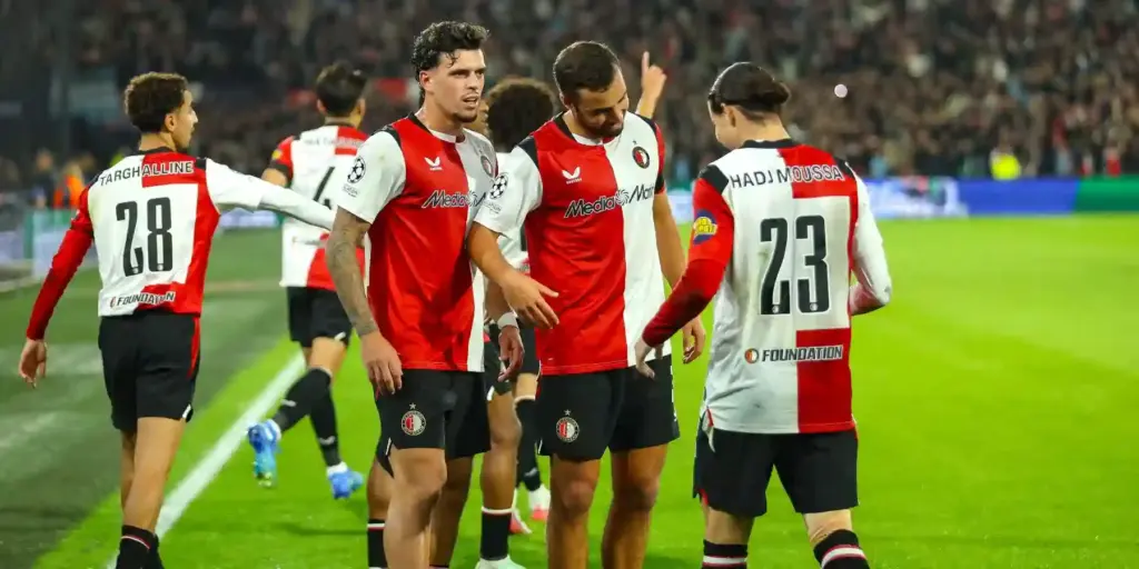Feyenoord players celebrate after scoring against Como