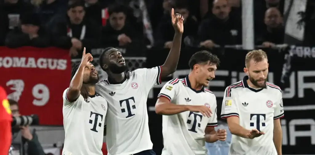 Serge Gnabry and Dayot Upamecano pointing to the skies during Bayern Munich goal celebration