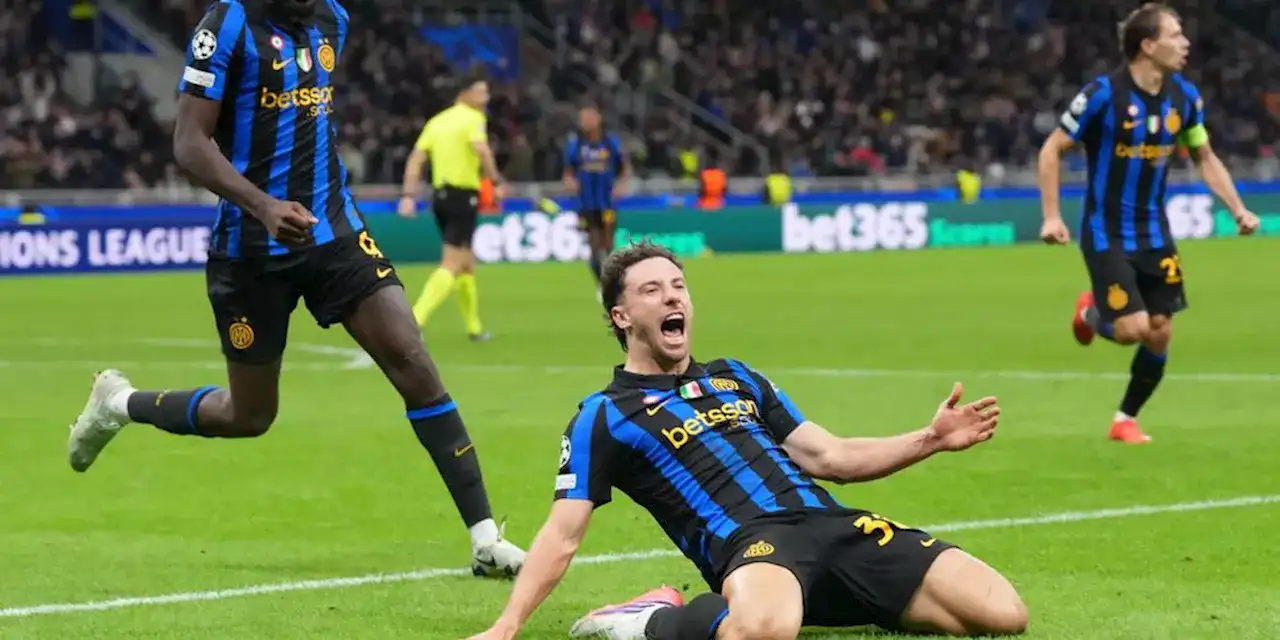 Inter's Carlos Augusto sliding on his knees after scoring against Shakhtar Donetsk