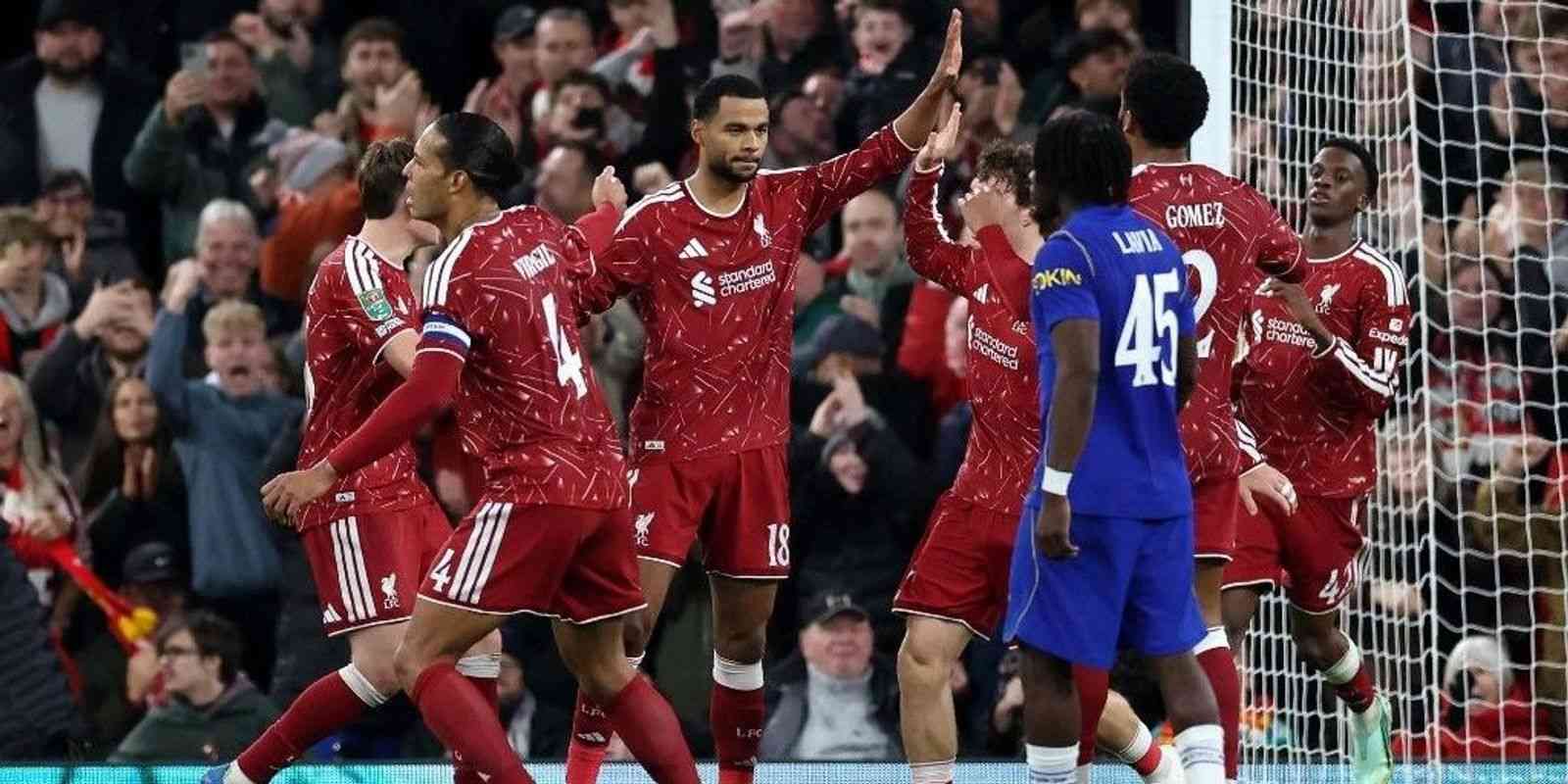 Liverpool players congratulate Cody Gakpo for scoring a penalty goal against Chelsea