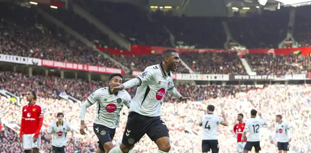 Rayan runs to celebrate after scoring against Manchester United