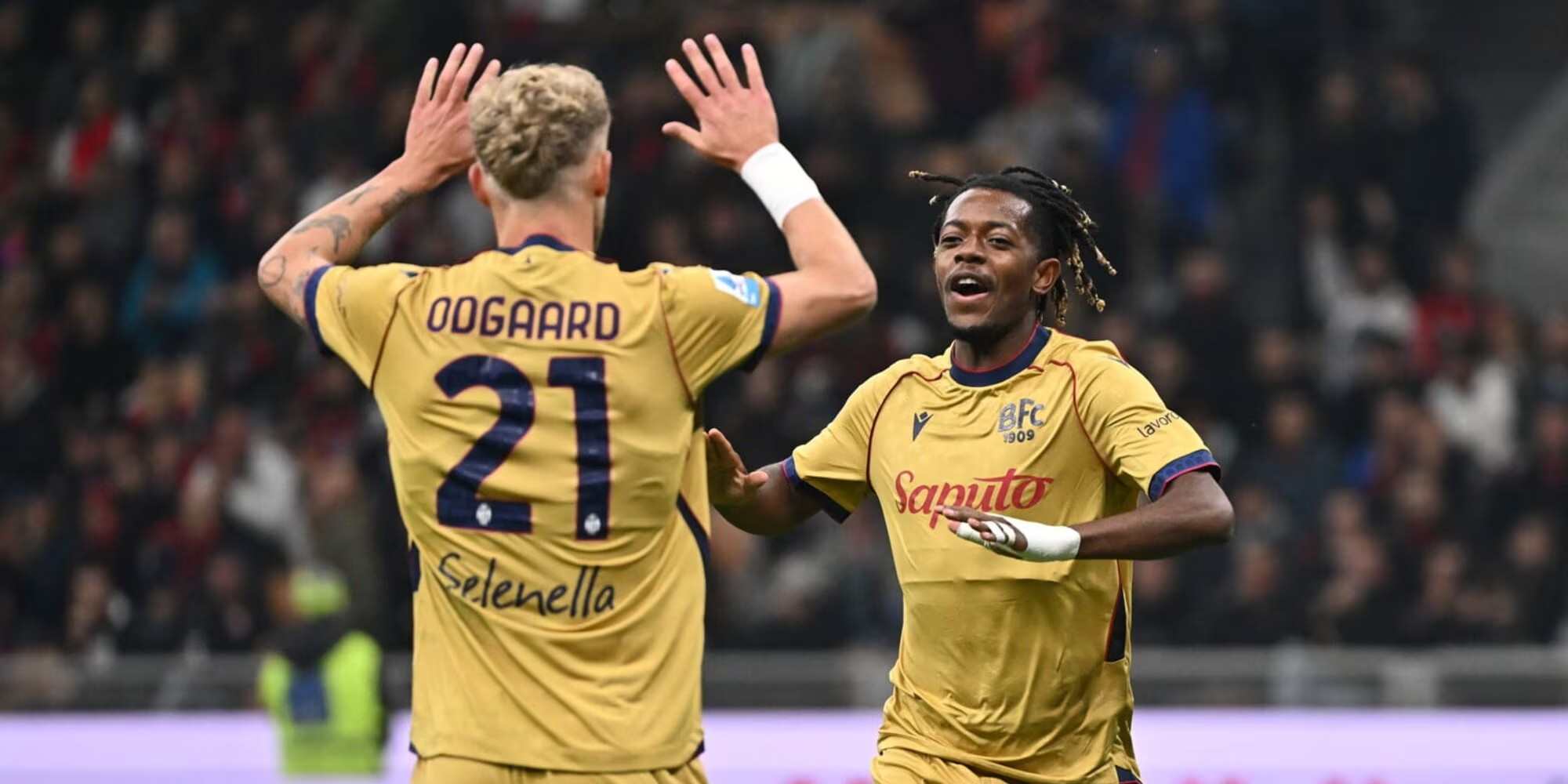 Bologna players celebrate after scoring against Milan