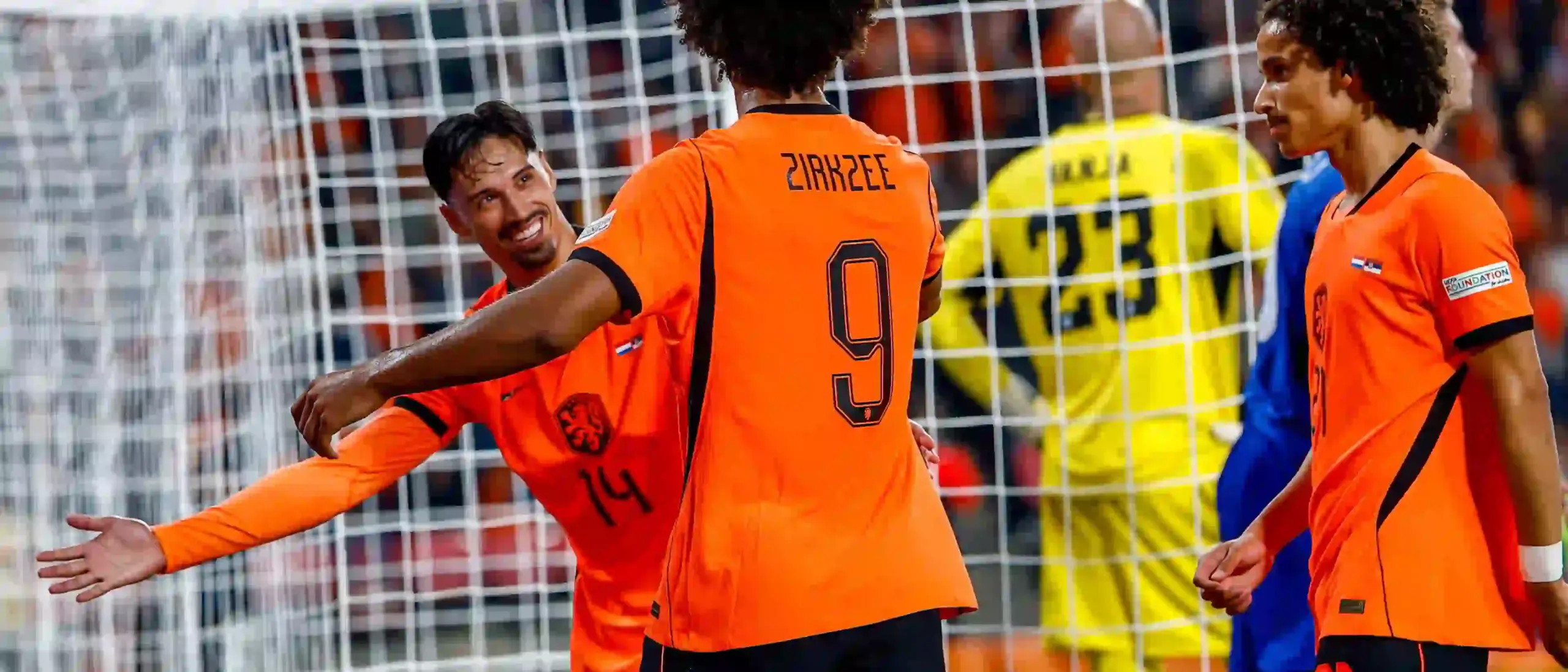 Dutch players celebrate after scoring against Serbia