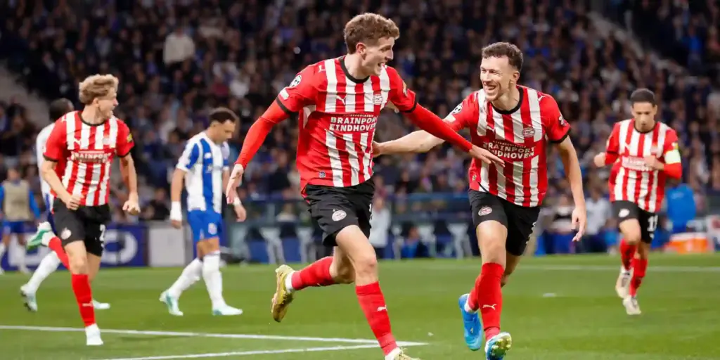 PSV players run to celebrate after scoring against Porto