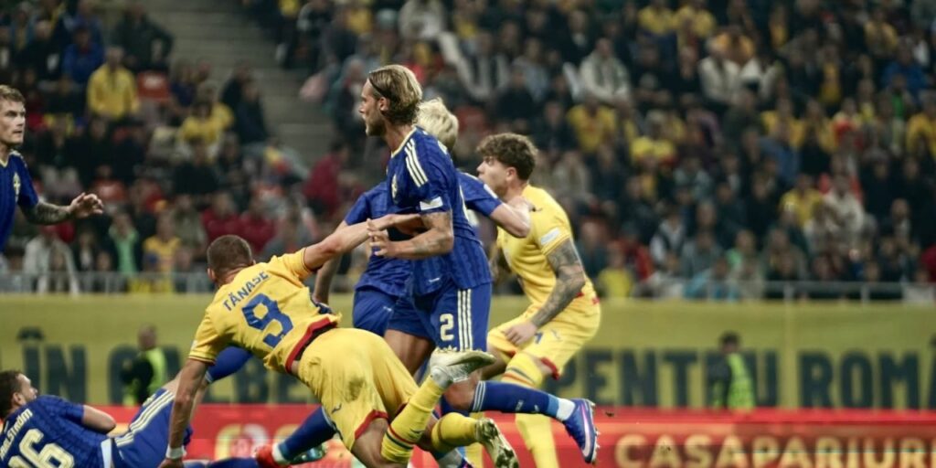 Romanian and Swedish players in a battle for the ball