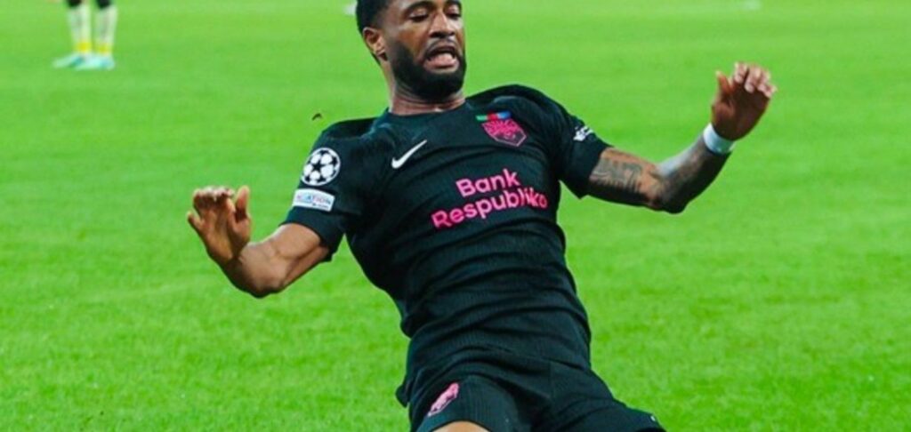 Joy-Lance Mickels sliding on his knees after scoring for Sabah against Slavia Prague