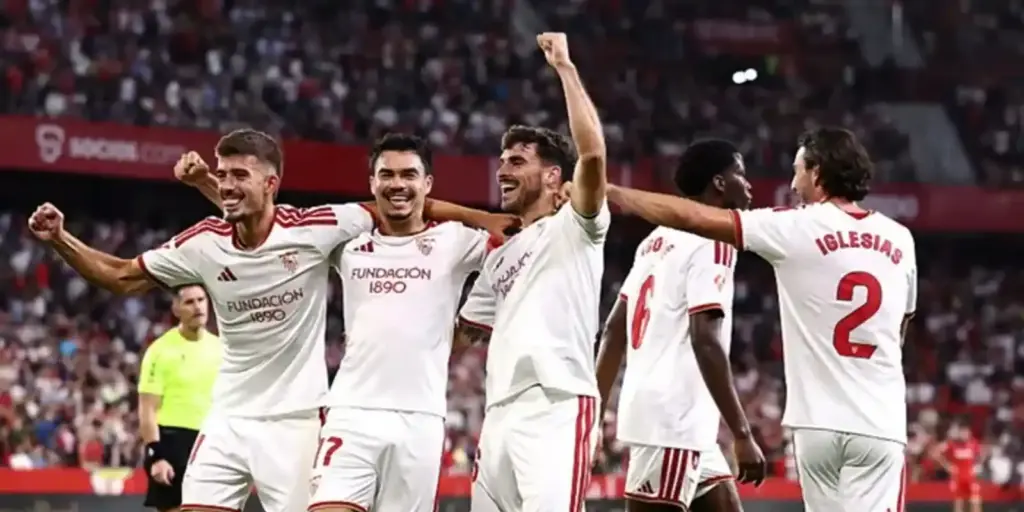 Sevilla players celebrate after scoring a goal