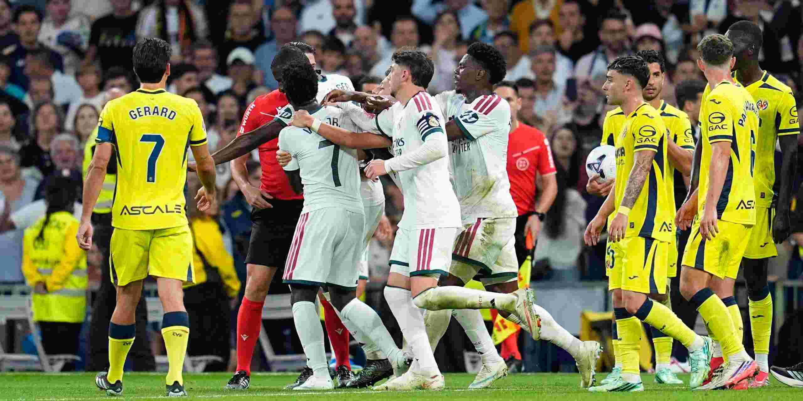 Real Madrid teammates trying to hold off Vinicius Jr after he was shown red card